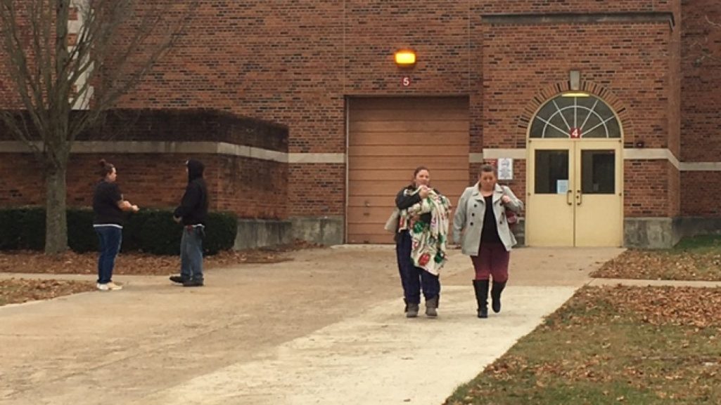 Two women walking our of a school