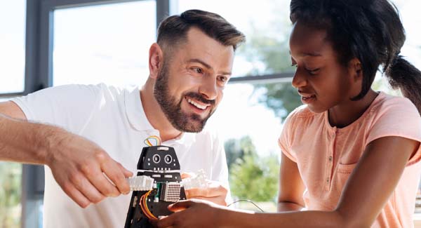 mentor and student working on a robot