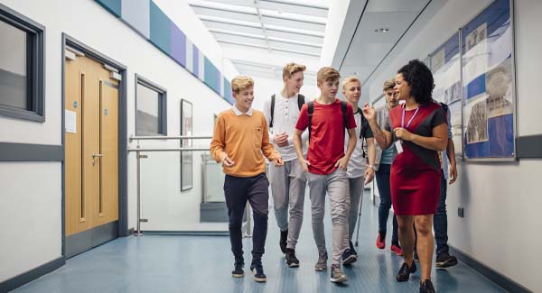 teacher walking students through hall