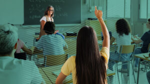 a student raising her hand in class to use a digital hall pass