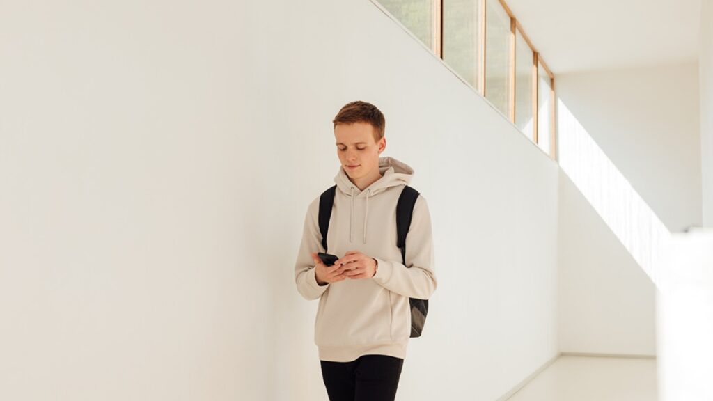 Young man walking in a school hallway