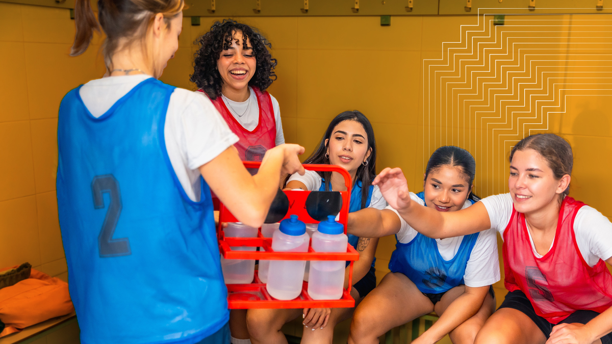 young female student-athletes getting water bottles in a locker room to prevent exertional heat stroke