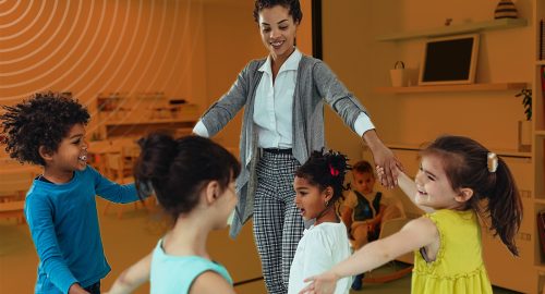 A woman leading children in a game at a daycare