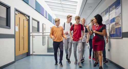 teacher walking students through hall